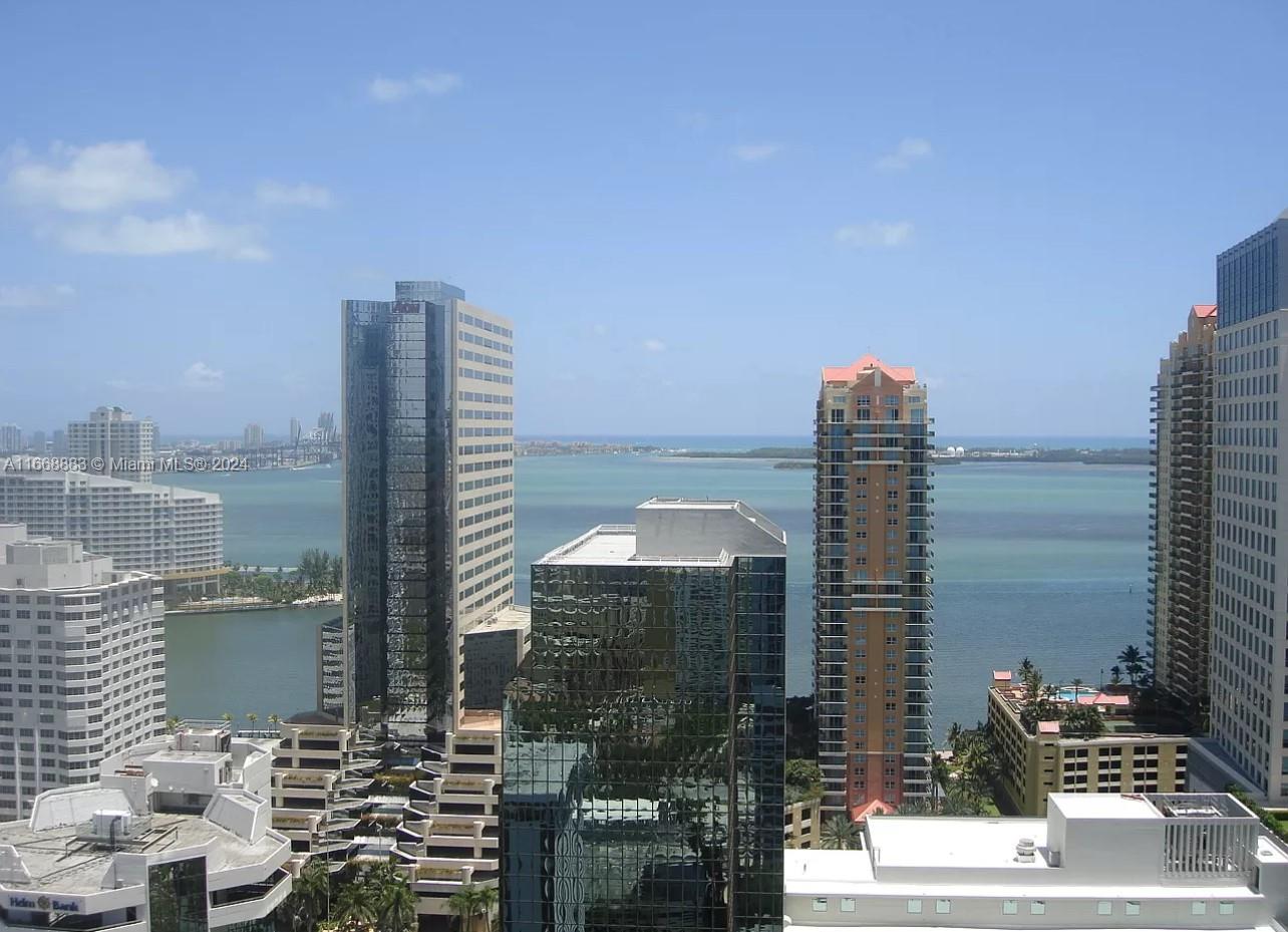 a city view with tall buildings and a bench