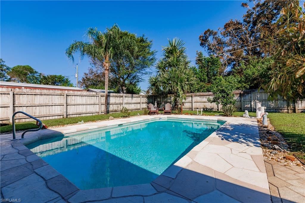 a view of a swimming pool with chairs