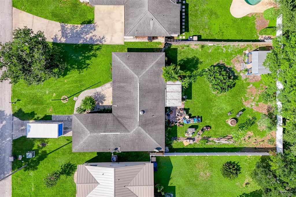 an aerial view of a house with a yard