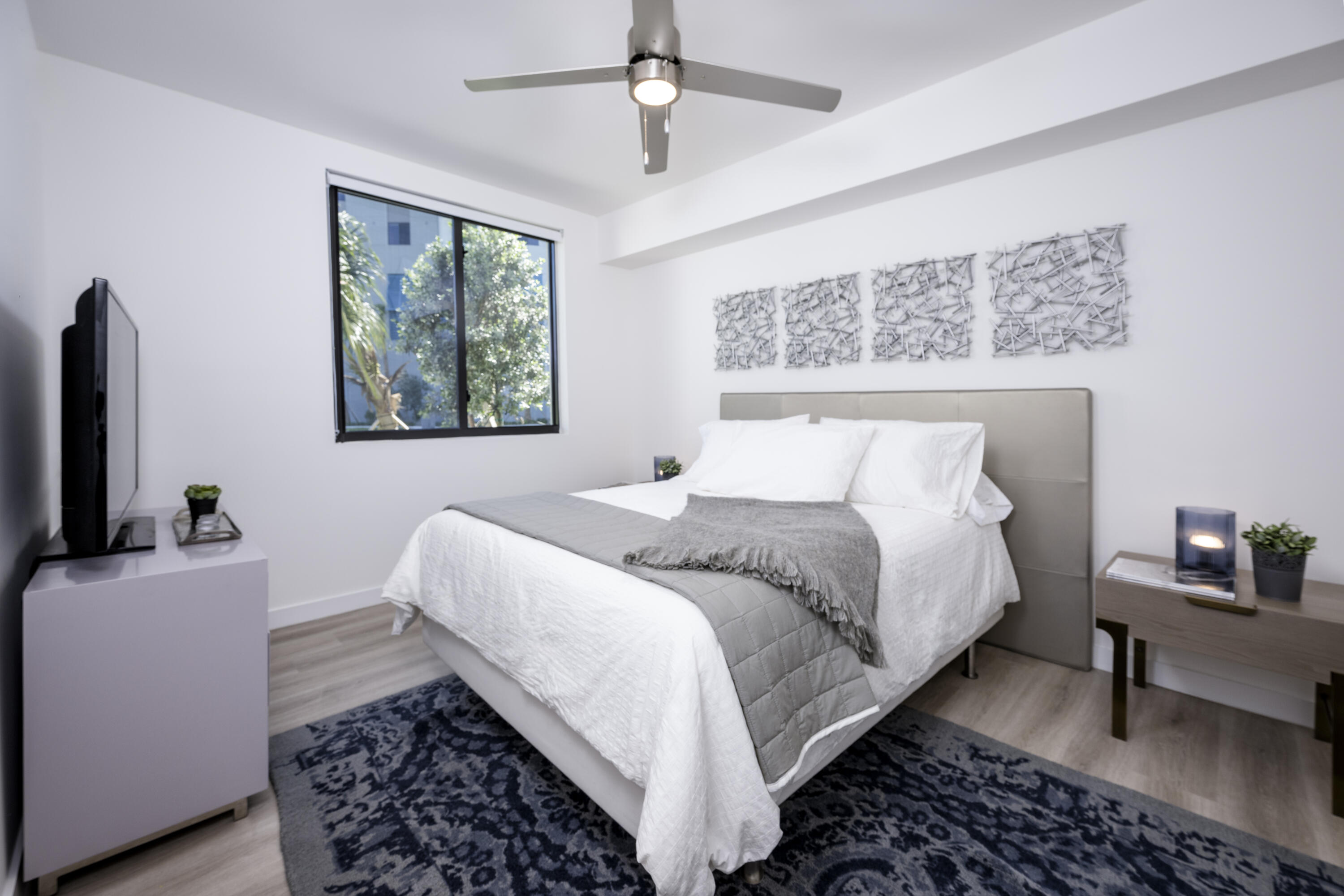 a bedroom with a bed and a flat screen tv