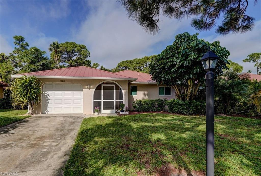 View of front of property with a garage and a front yard