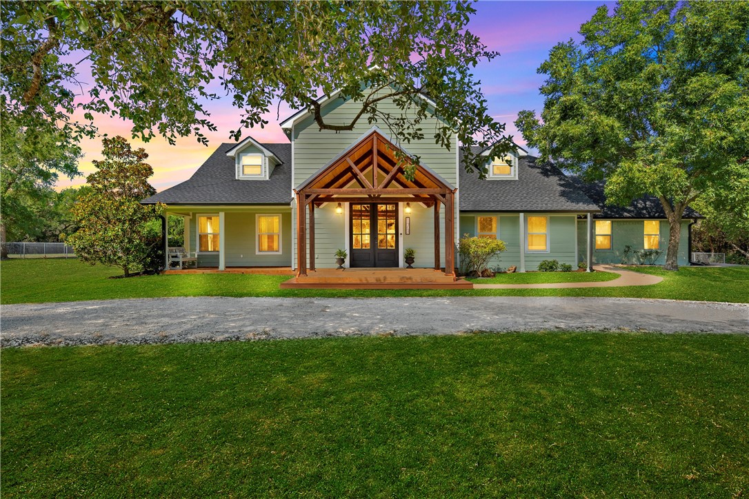 a front view of a house with a garden