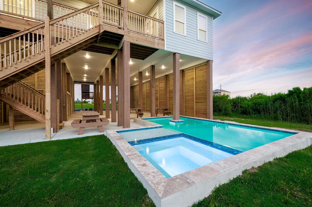 a view of a house with pool and a yard