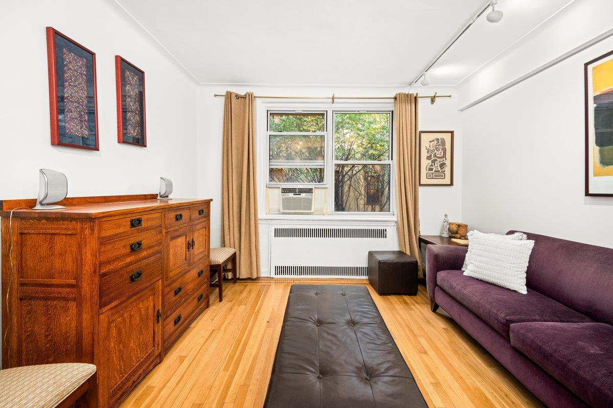 a bedroom with furniture and wooden floor