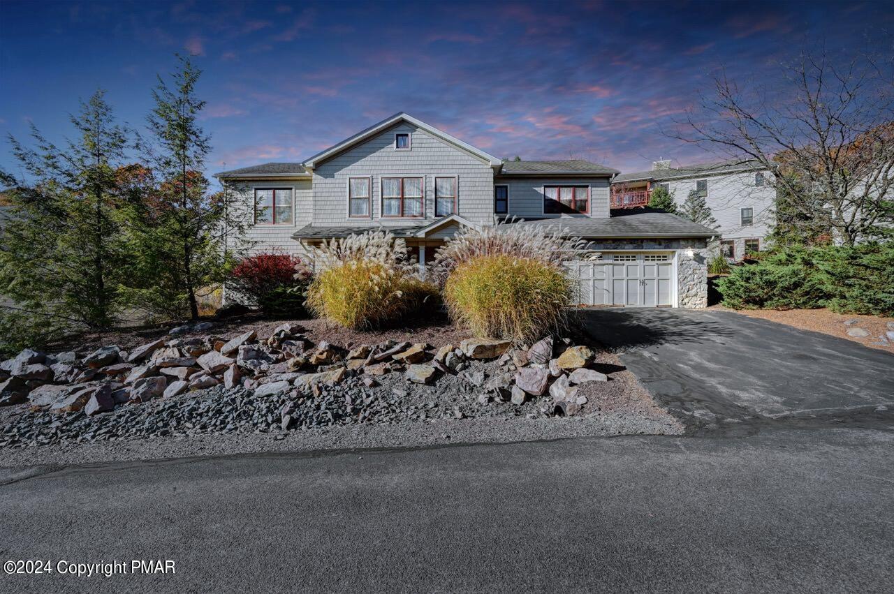 a front view of a house with a garden and pathway