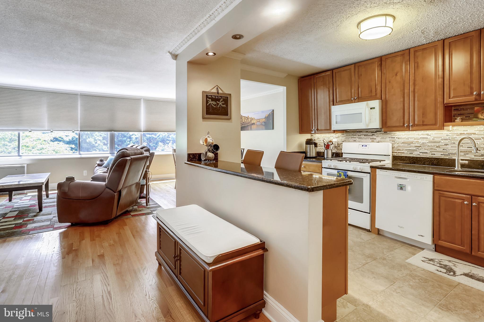 a kitchen with counter top space a sink cabinets and appliances