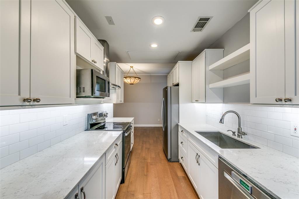 a kitchen with a sink stove and cabinets