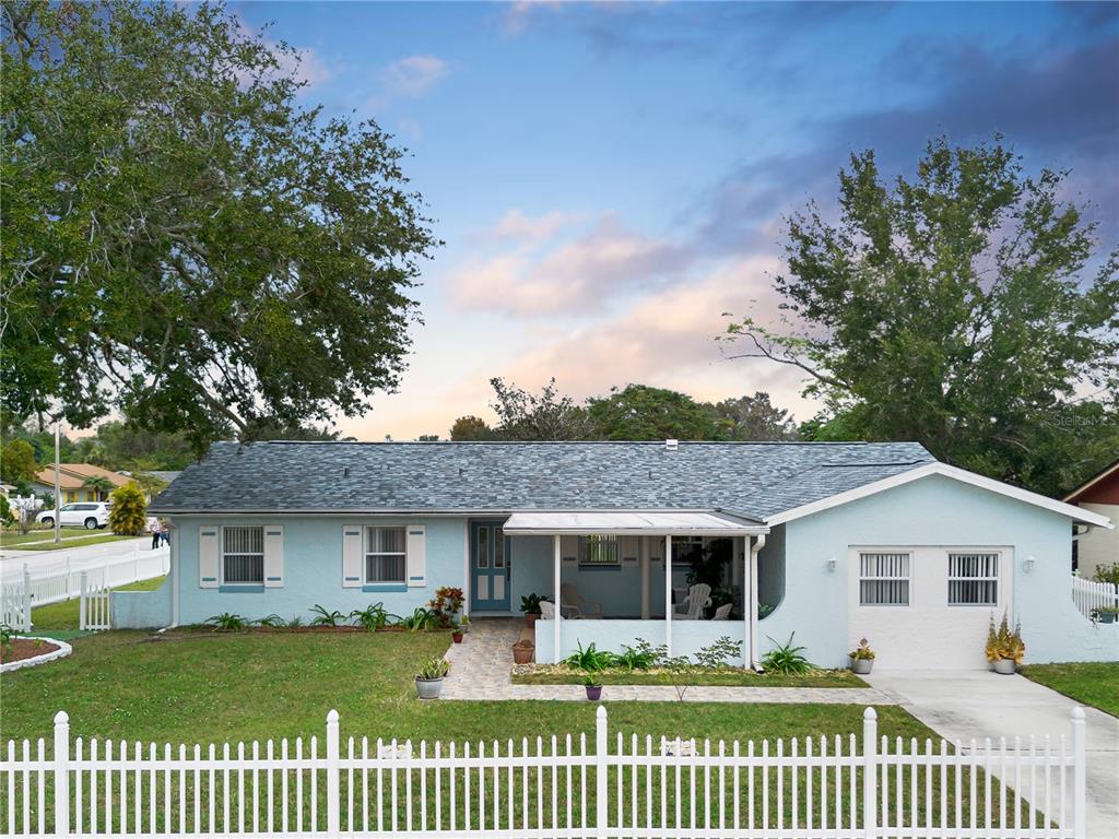 a front view of house with yard and green space