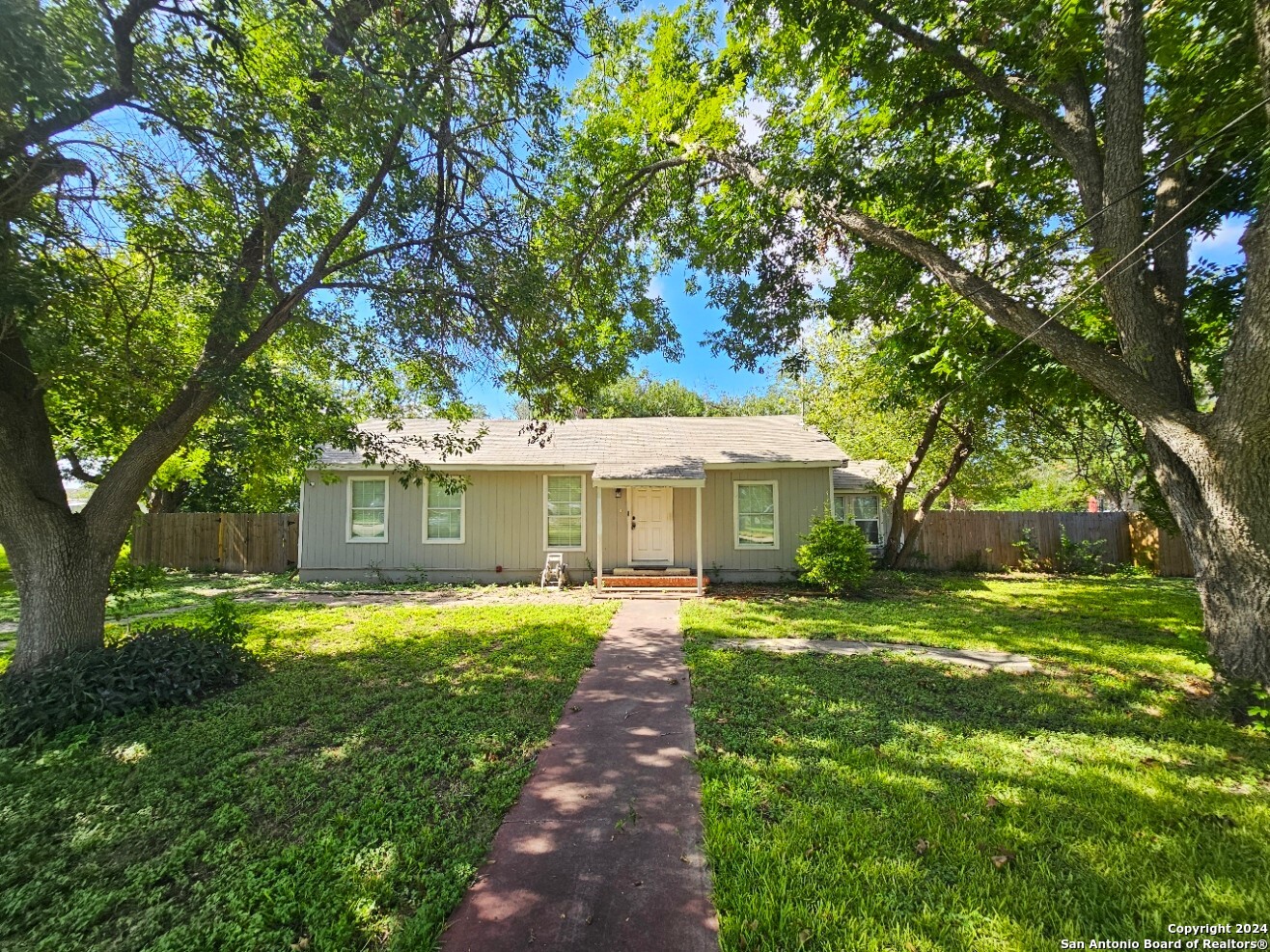 a front view of a house with yard garden and patio