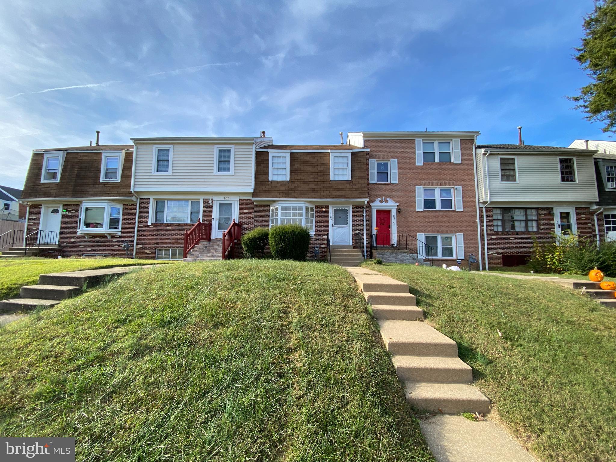 a front view of a residential apartment building with a yard