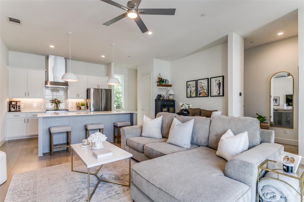 a living room with furniture and a view of kitchen