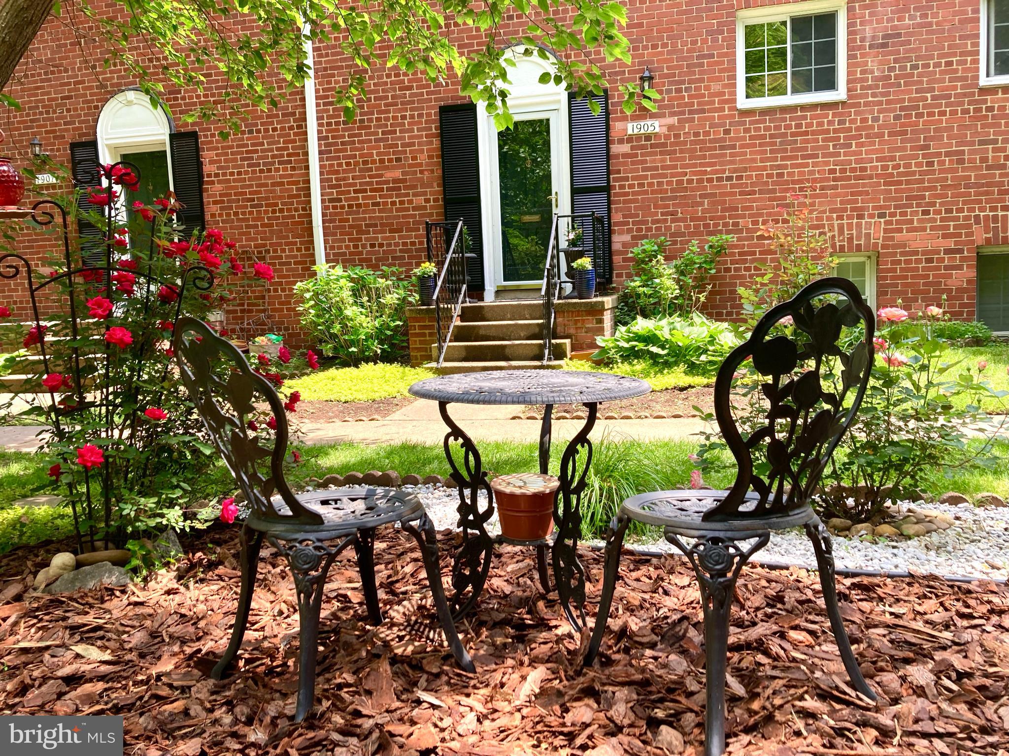 a view of a house with a backyard and a patio