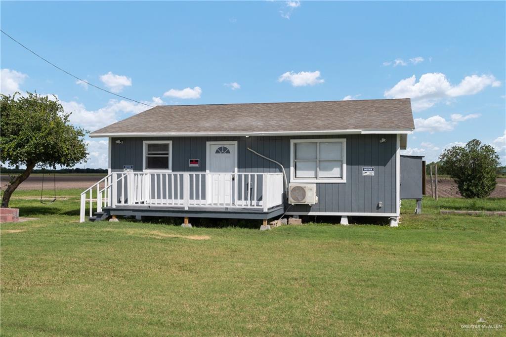 a view of a house with a backyard and deck