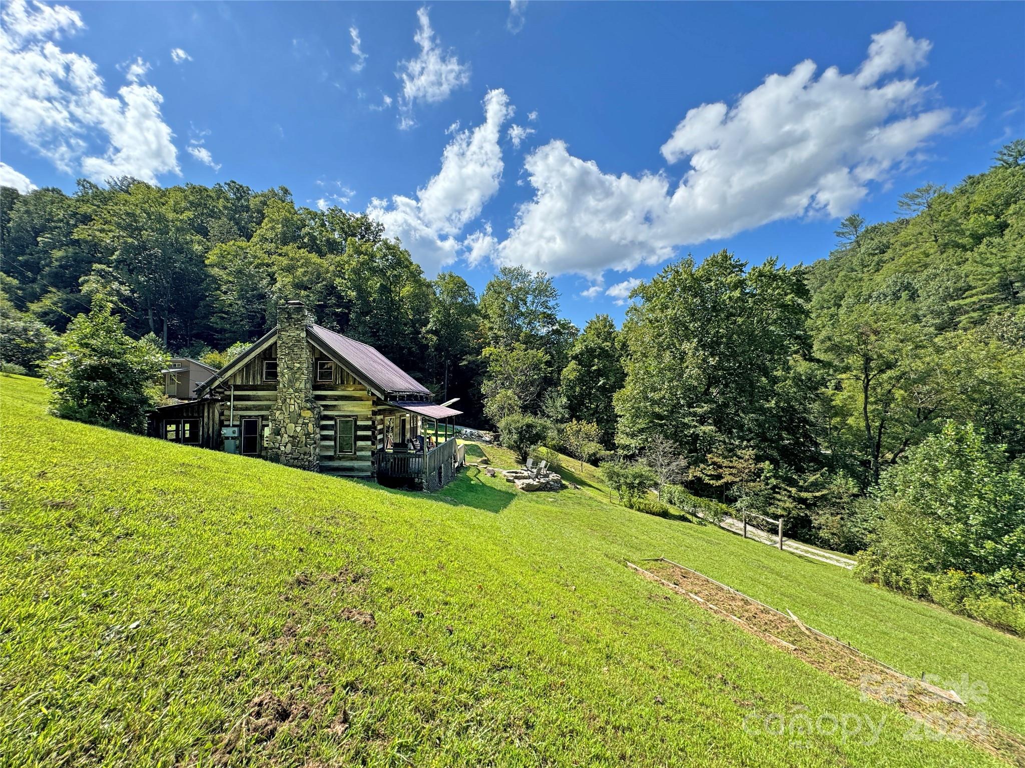 a view of a house with a big yard and garden