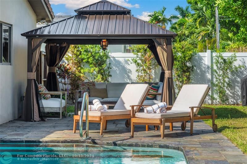 a view of roof deck with chairs and tables