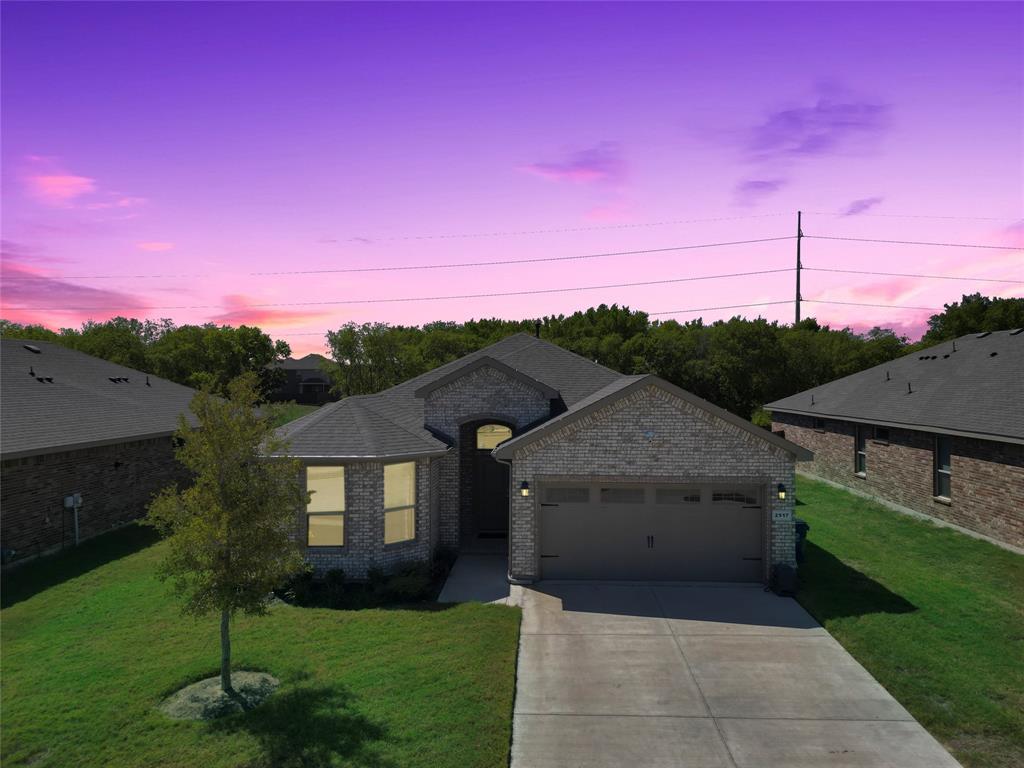 a front view of a house with a yard