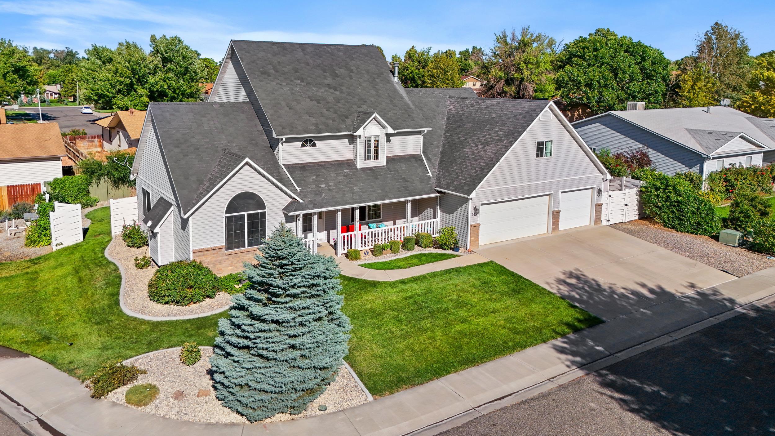 a aerial view of a house with yard and green space