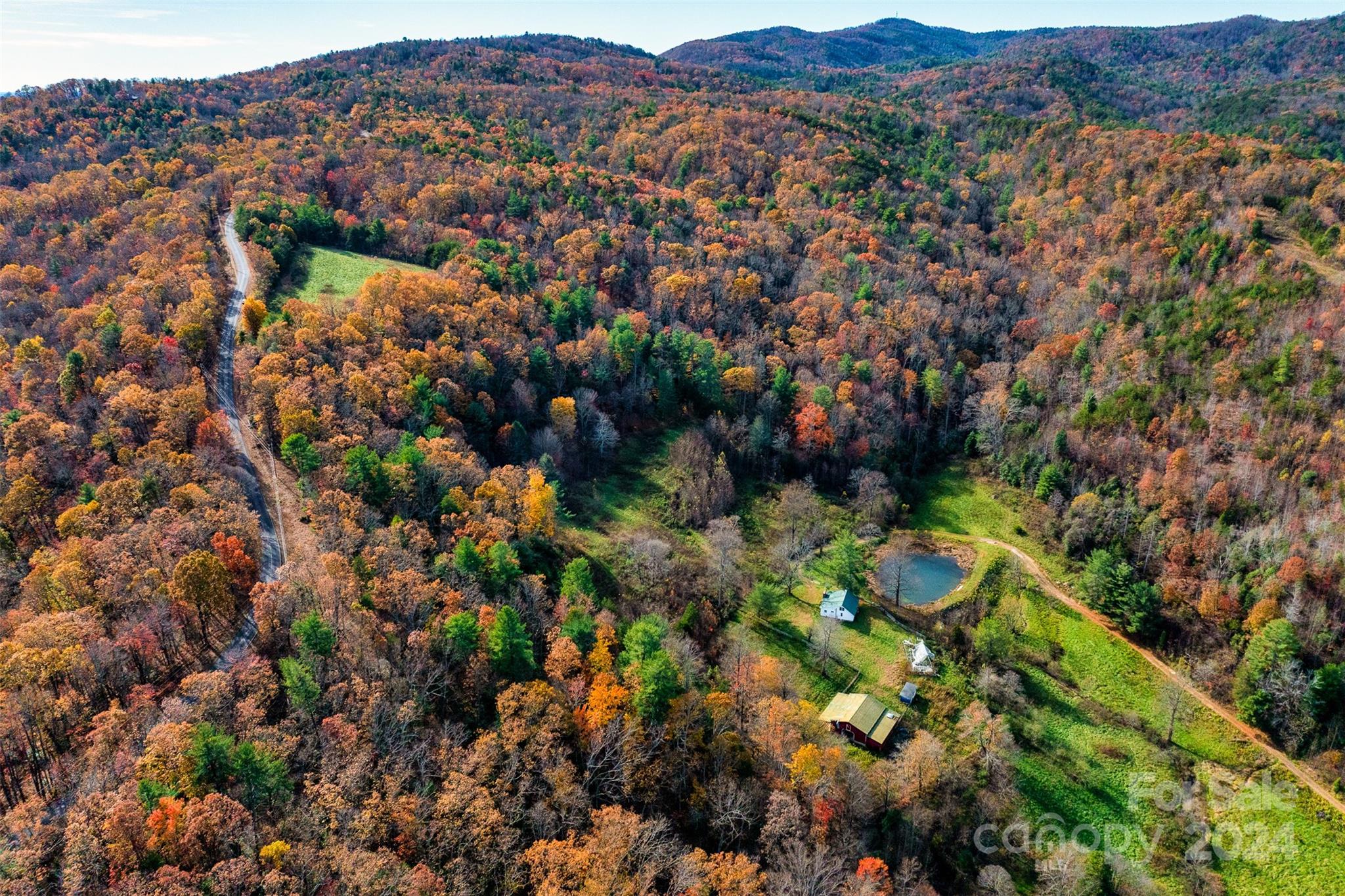 an aerial view of residential house with parking and mountain view