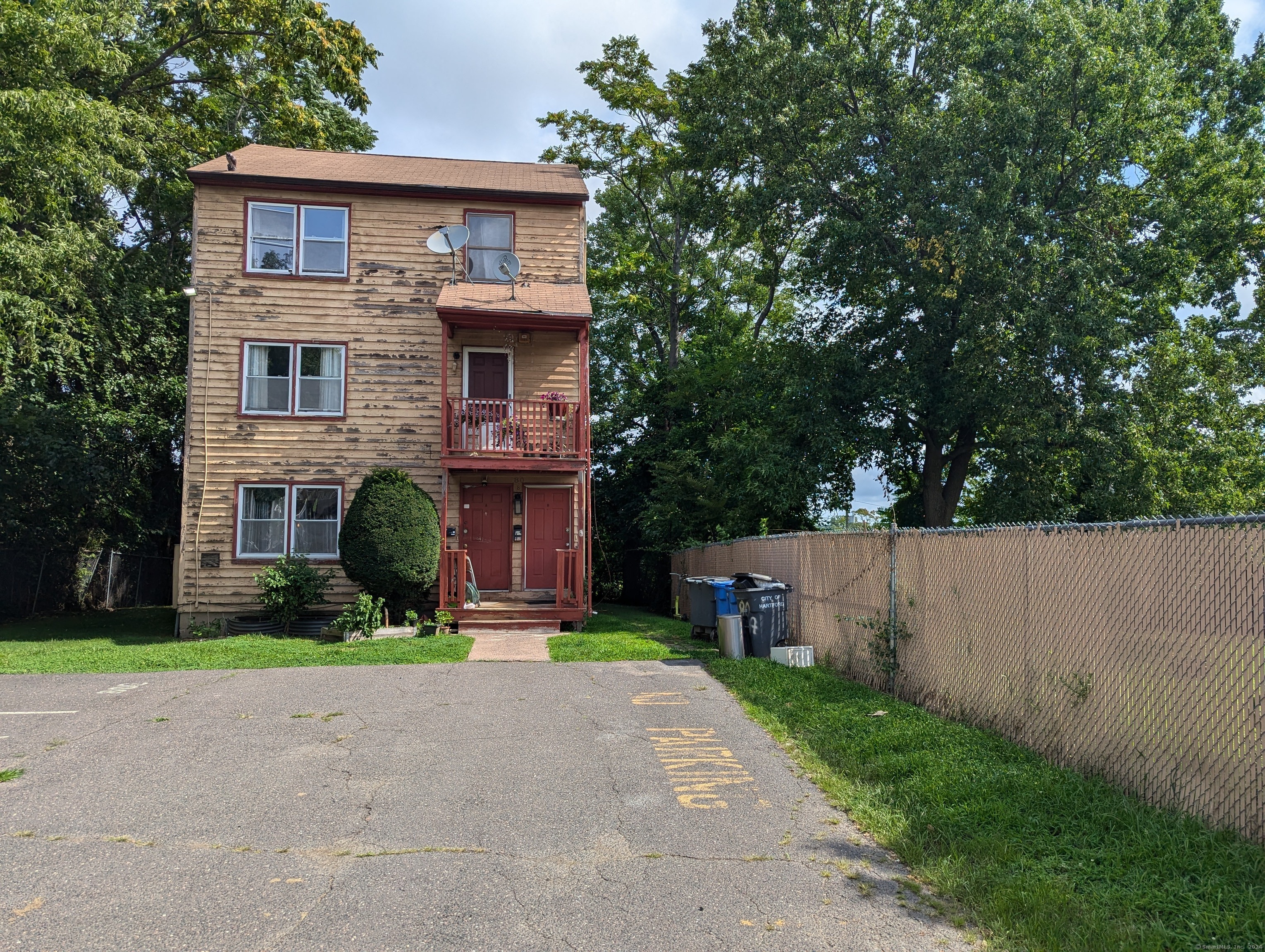 a front view of a house with a yard and trees