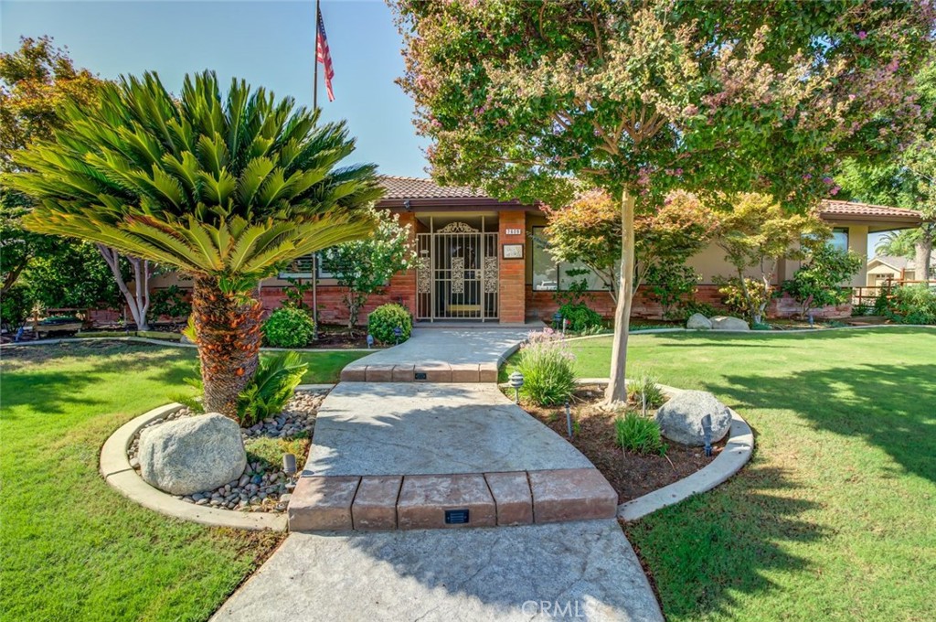 a front view of a house with garden