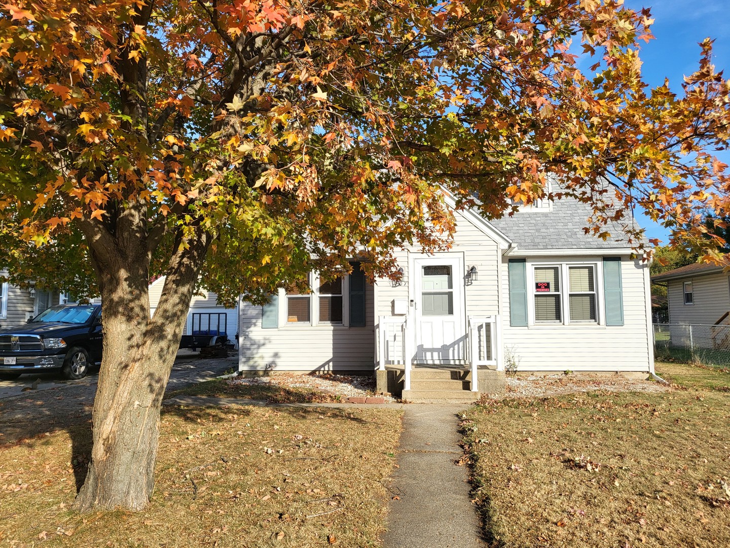 a front view of a house with a yard covered with snow