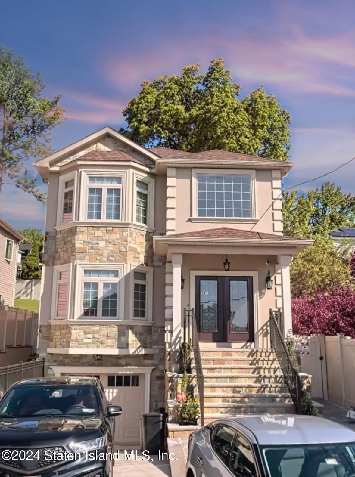 a front view of a house with a garden