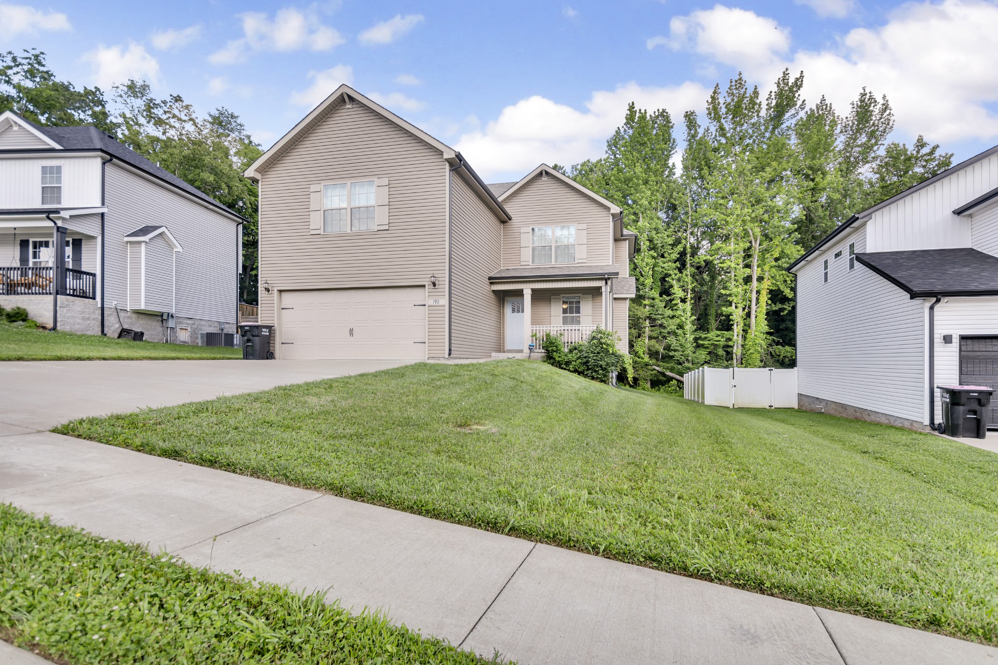 a front view of house with yard and green space