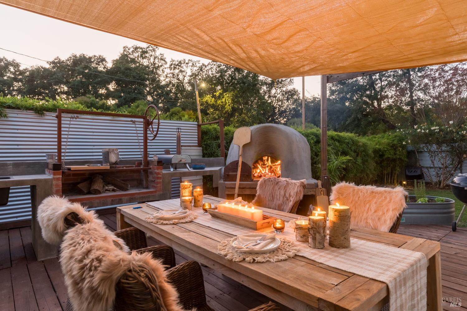 a view of deck with table and chairs a barbeque grill with wooden fence