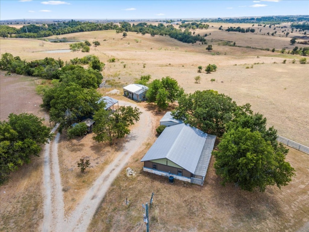 an aerial view of ocean with residential house and outdoor space