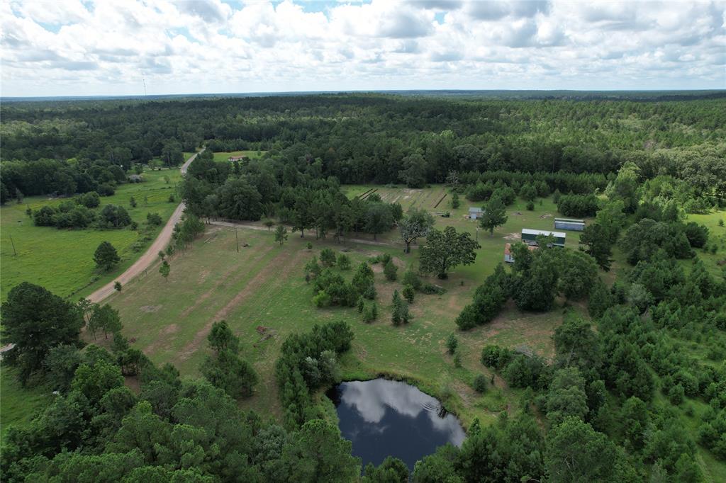 an aerial view of a houses with outdoor space and trees