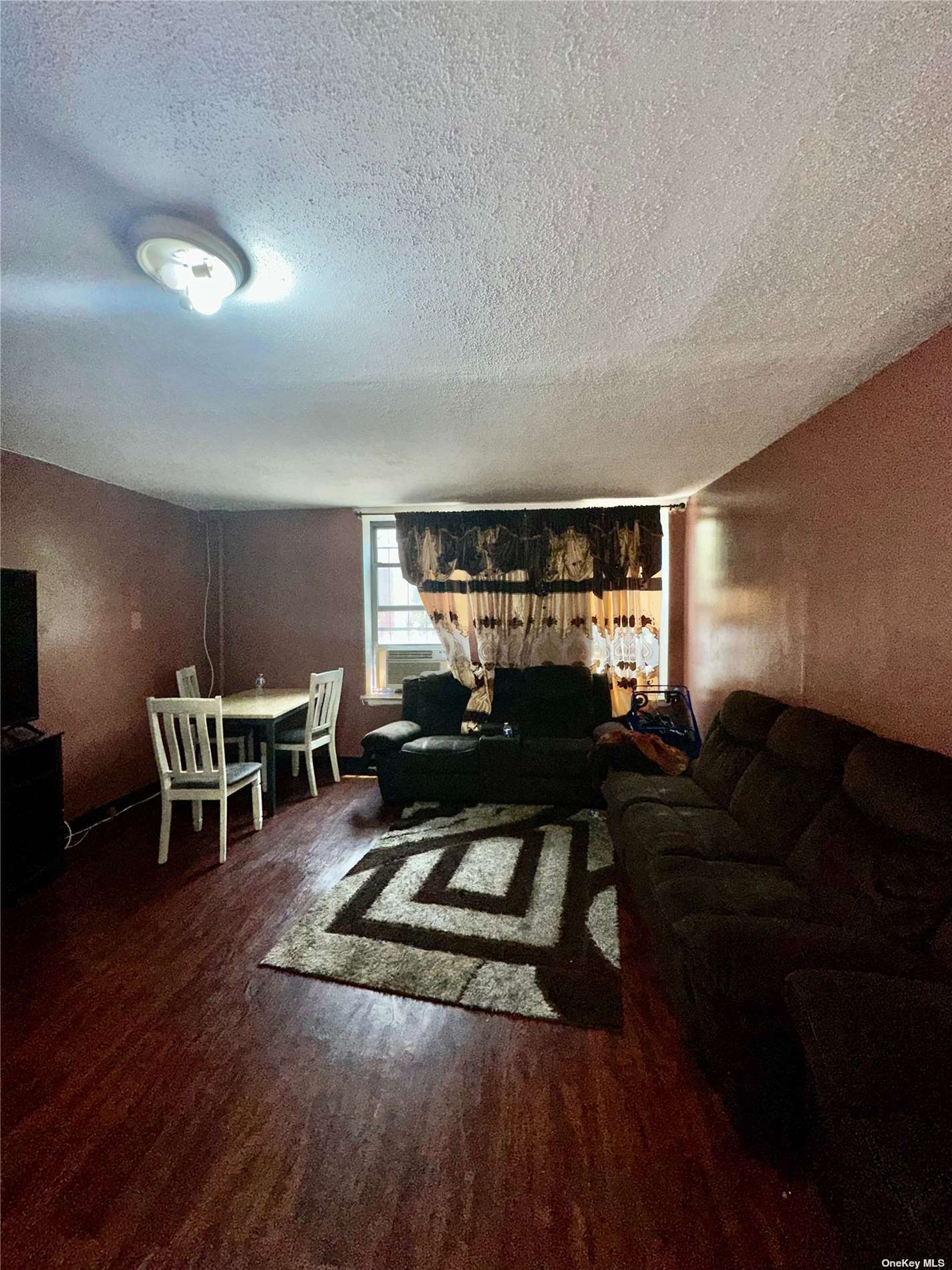 a living room with furniture a rug and a flat screen tv