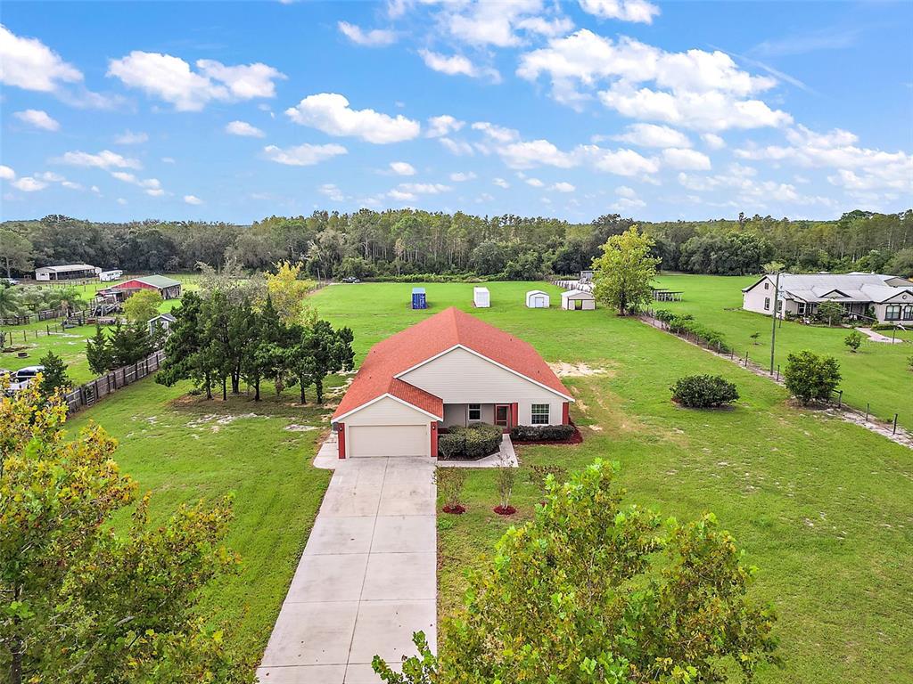 an aerial view of a house with big yard