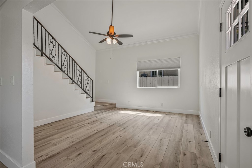 a view of a hallway with wooden floor and staircase