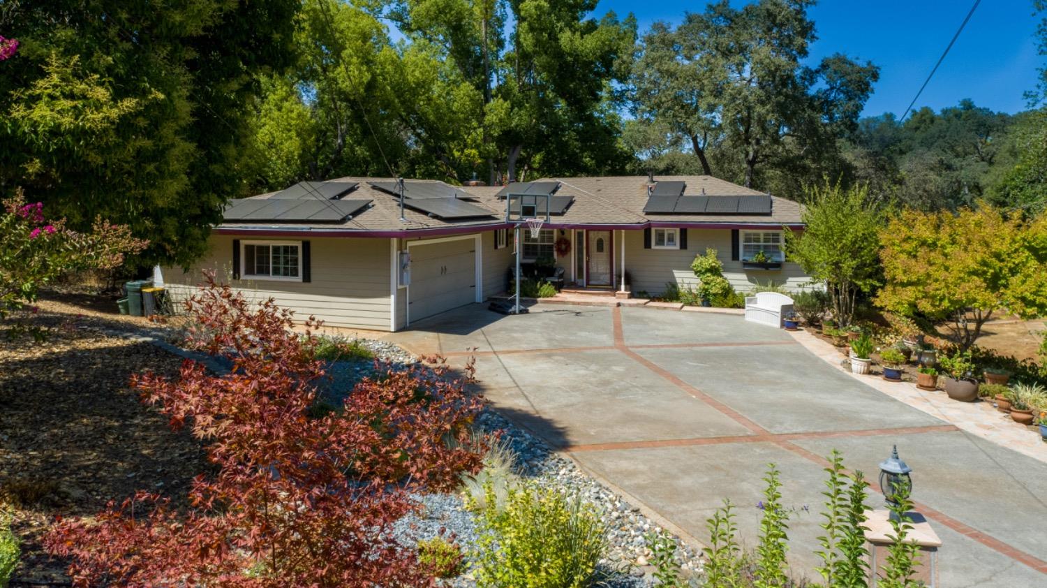 a front view of a house with a garden