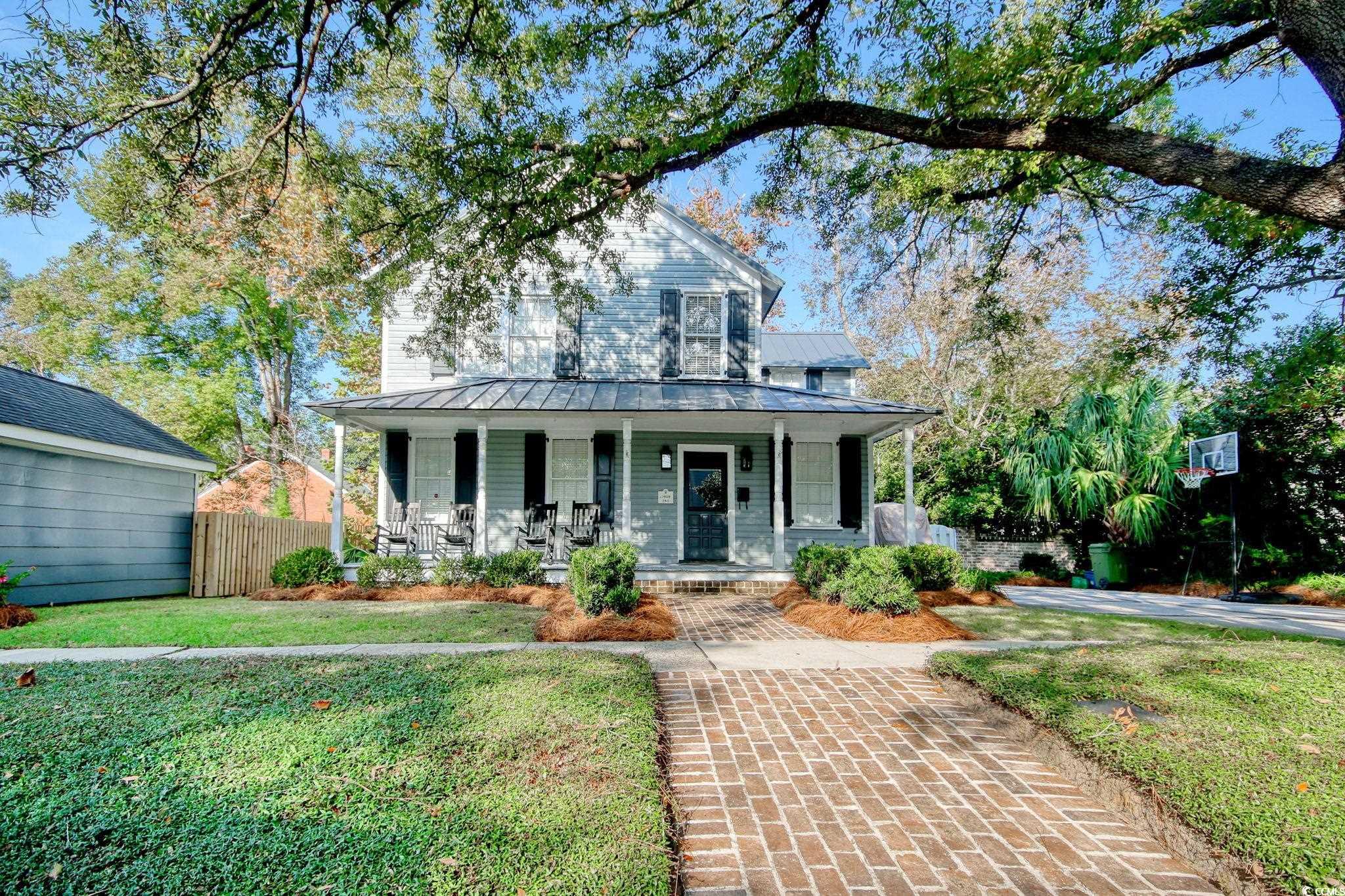 View of front of home featuring a porch and a fron