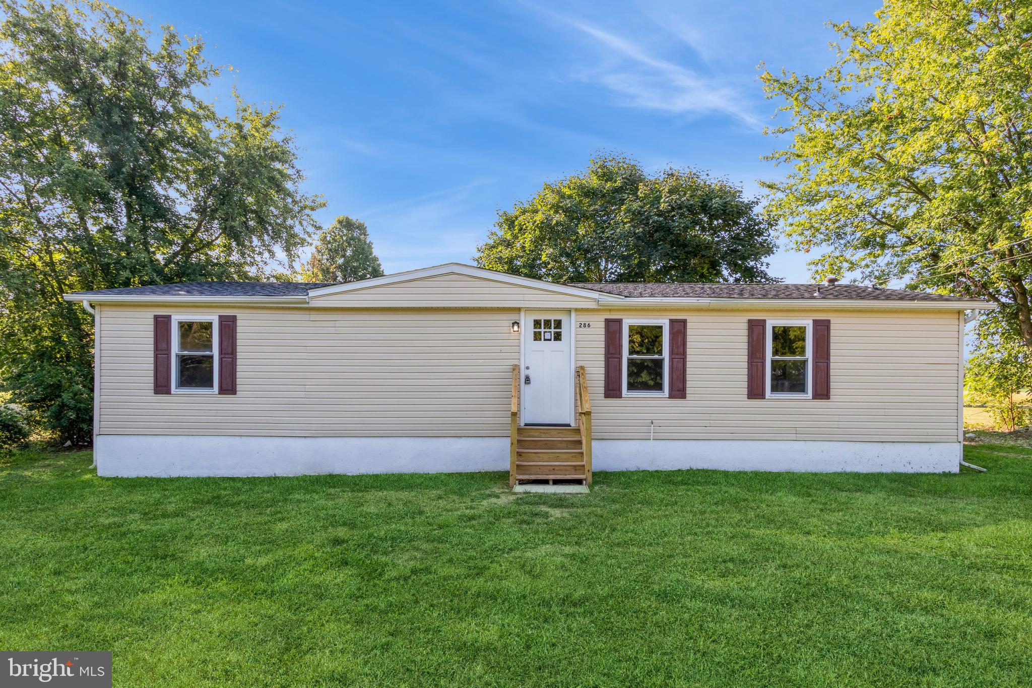 a front view of house with yard and green space