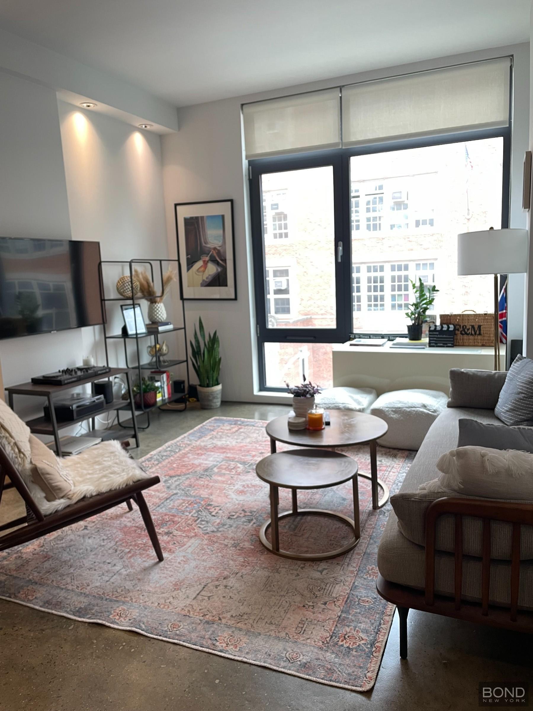 a living room with furniture and a large window