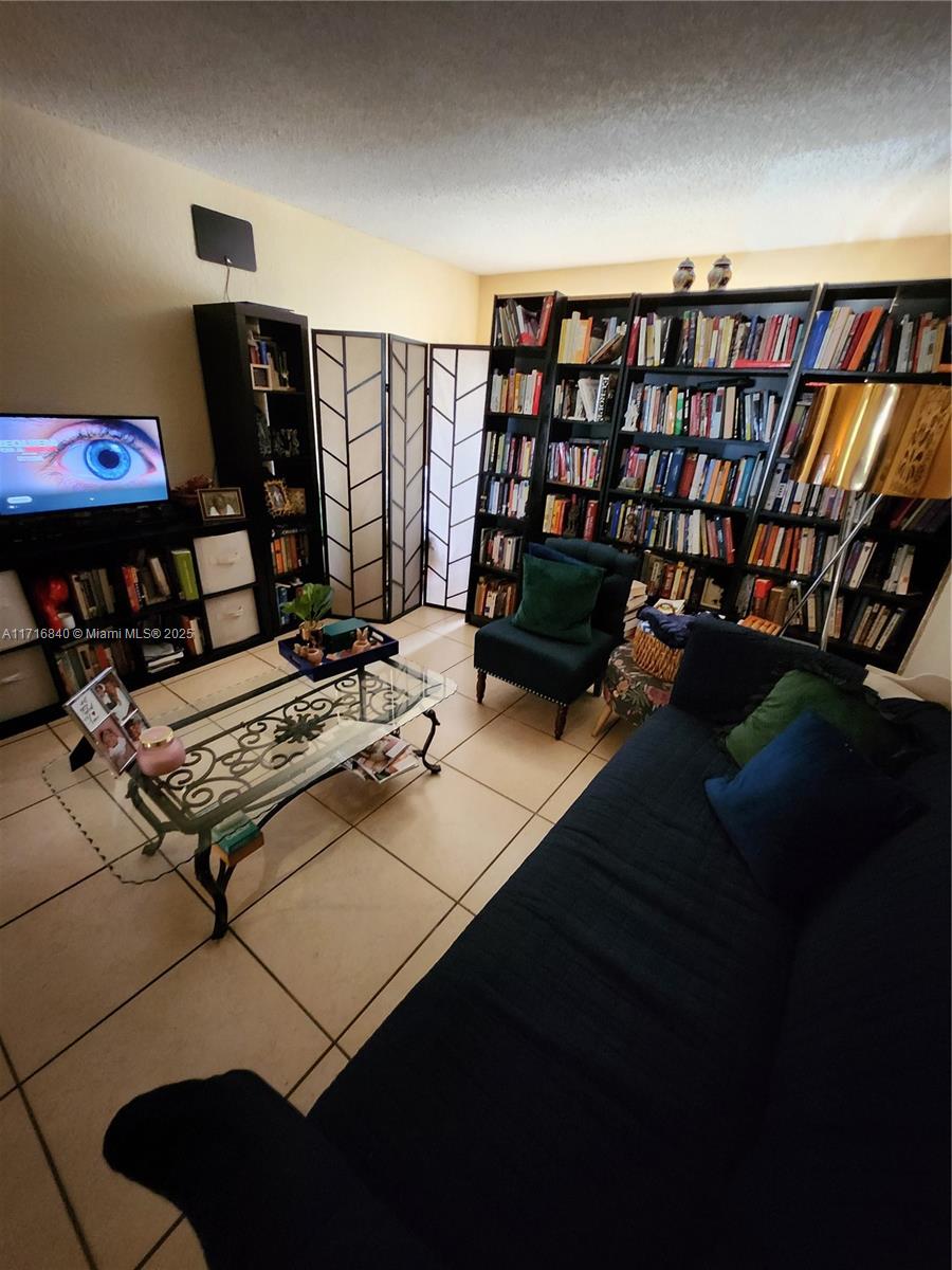 a living room with furniture and a book shelf