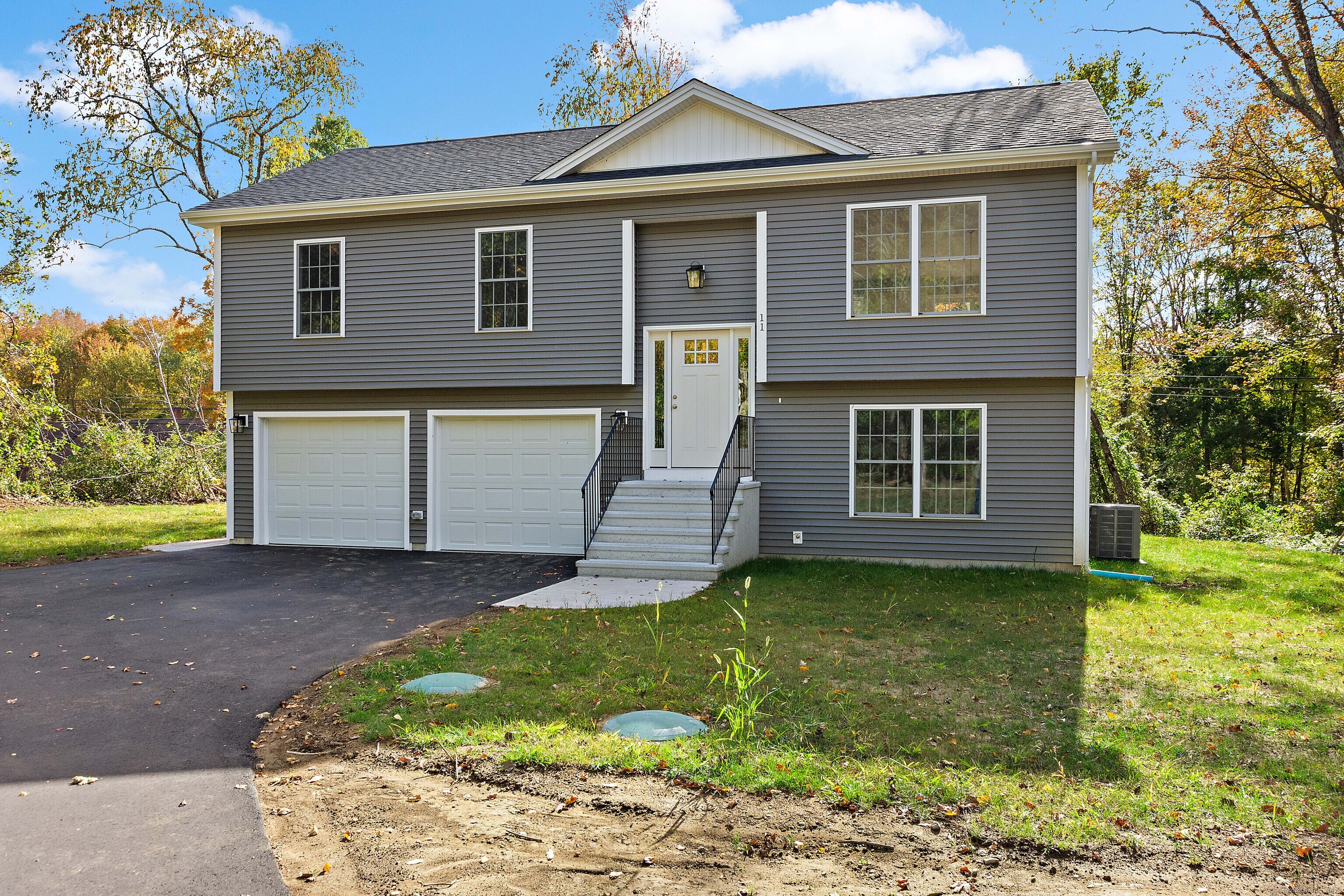 a front view of a house with a yard and garage