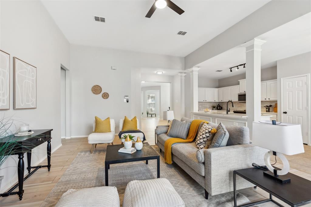 a living room with furniture and kitchen view