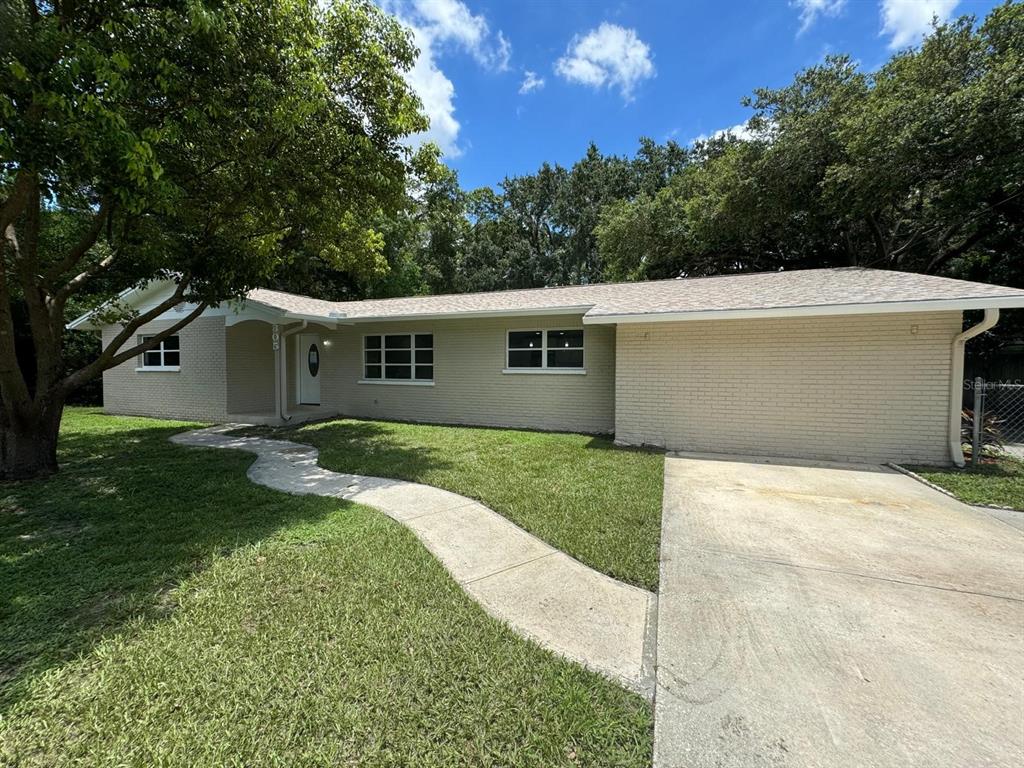 a view of a house with a backyard