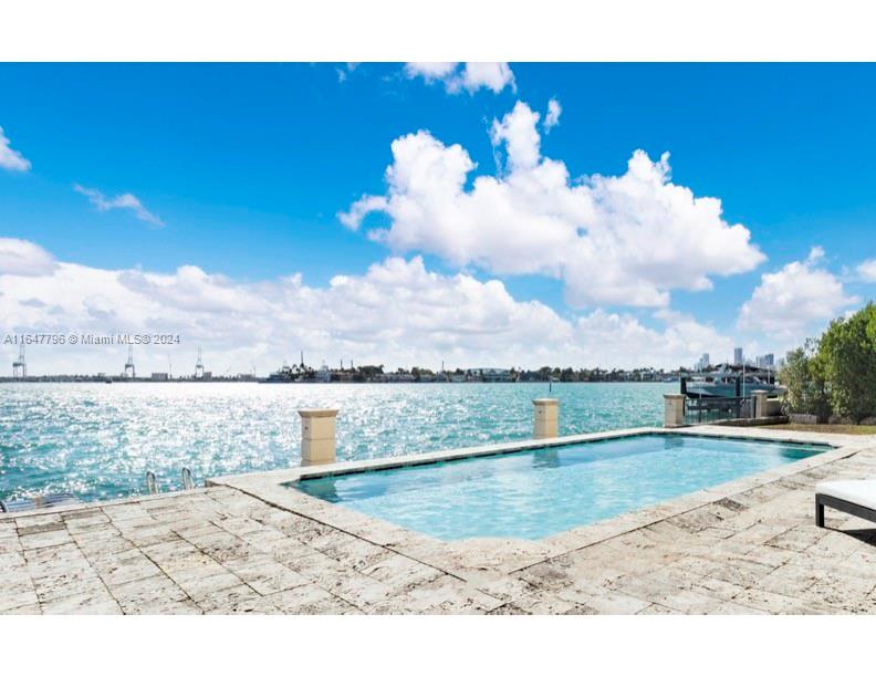 a view of a swimming pool with a yard