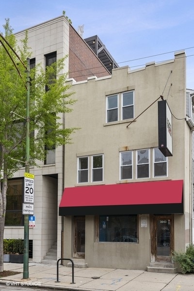 a building with potted plants in front of it