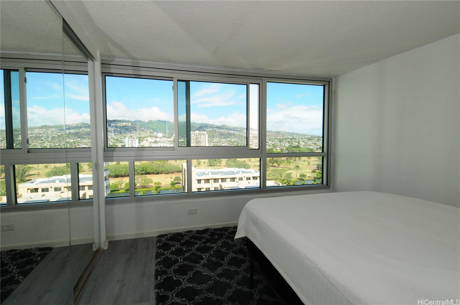 a bed sitting in a bedroom next to a window