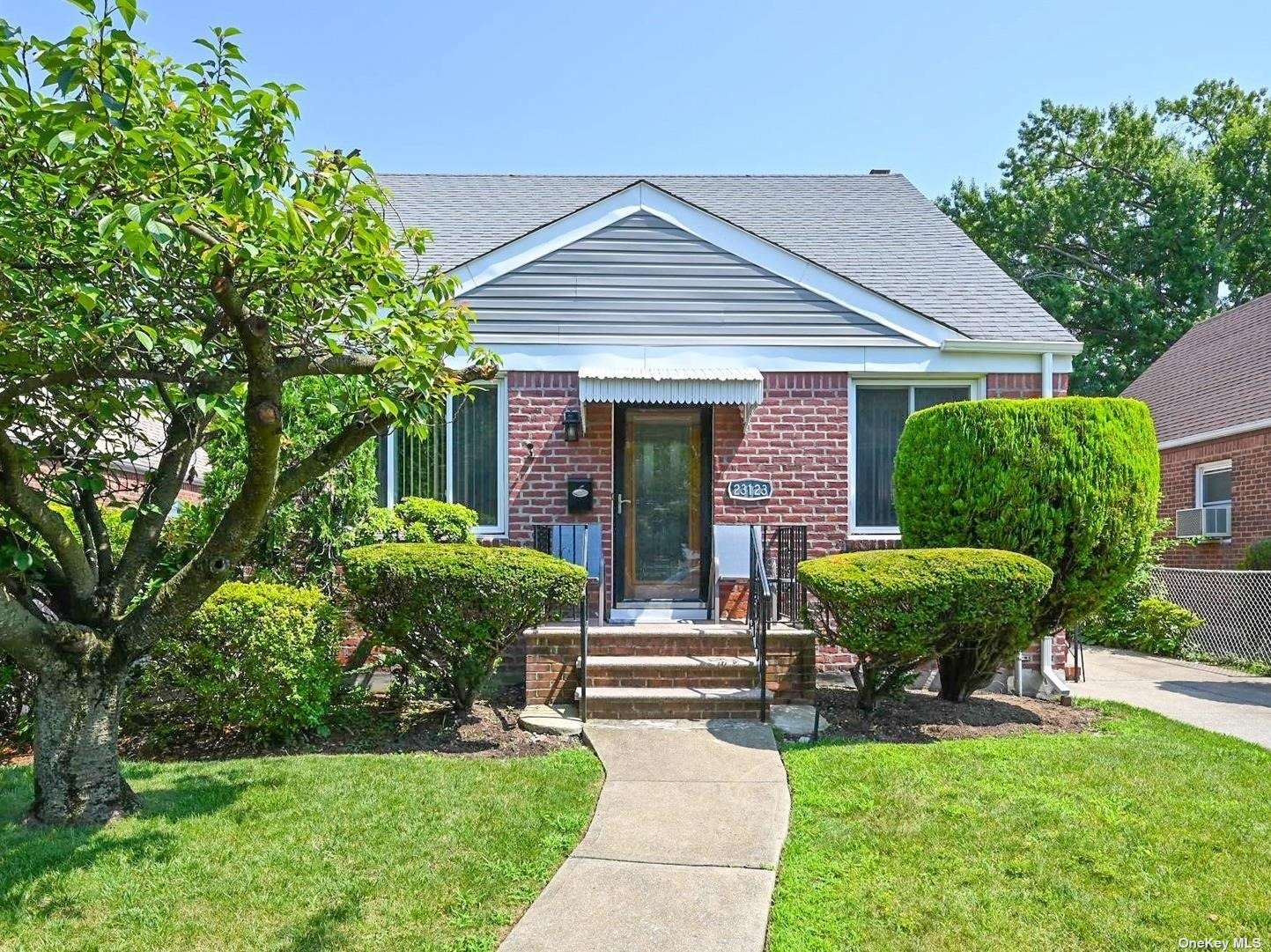 a front view of a house with garden and porch