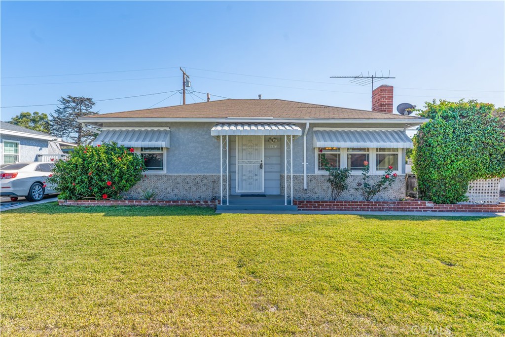 a front view of house with yard and swimming pool