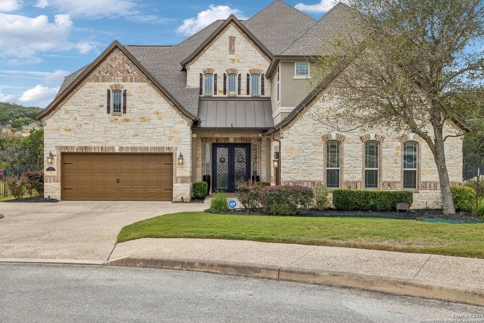 a front view of a house with a yard and garage