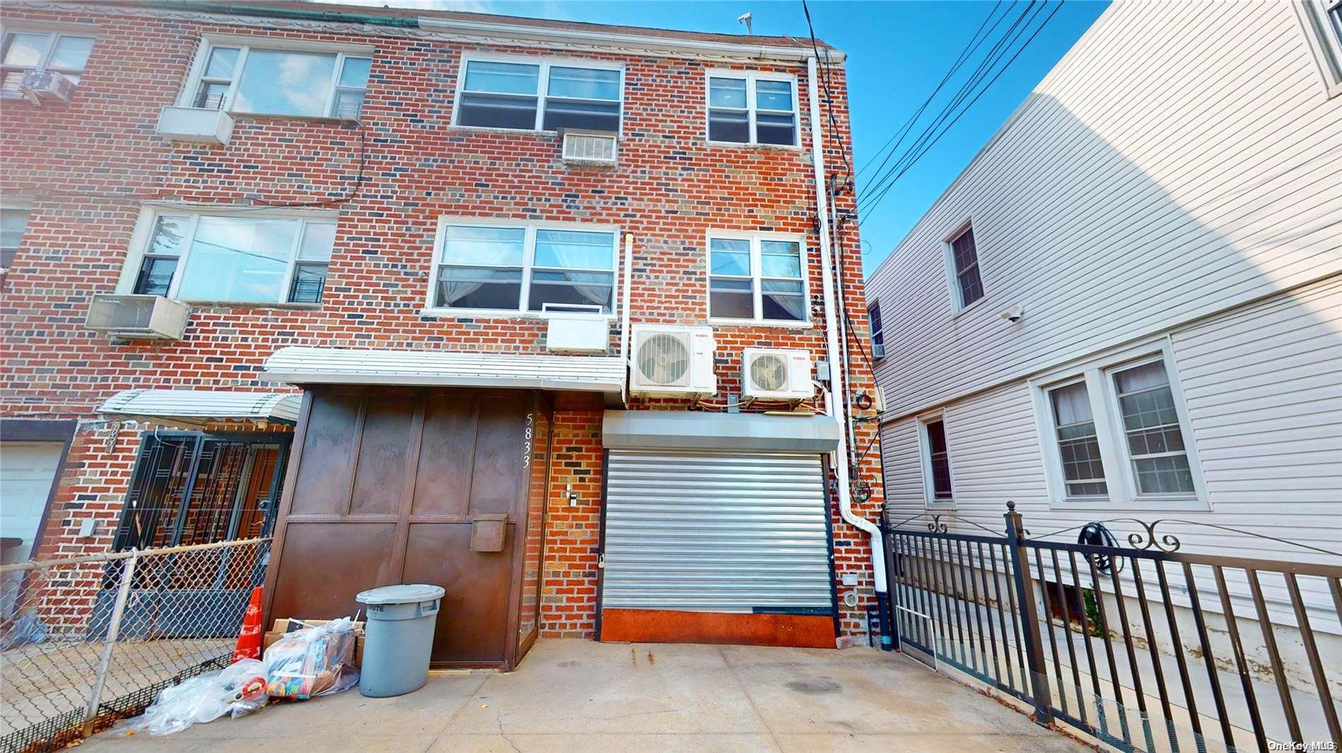 a view of a brick house with many windows