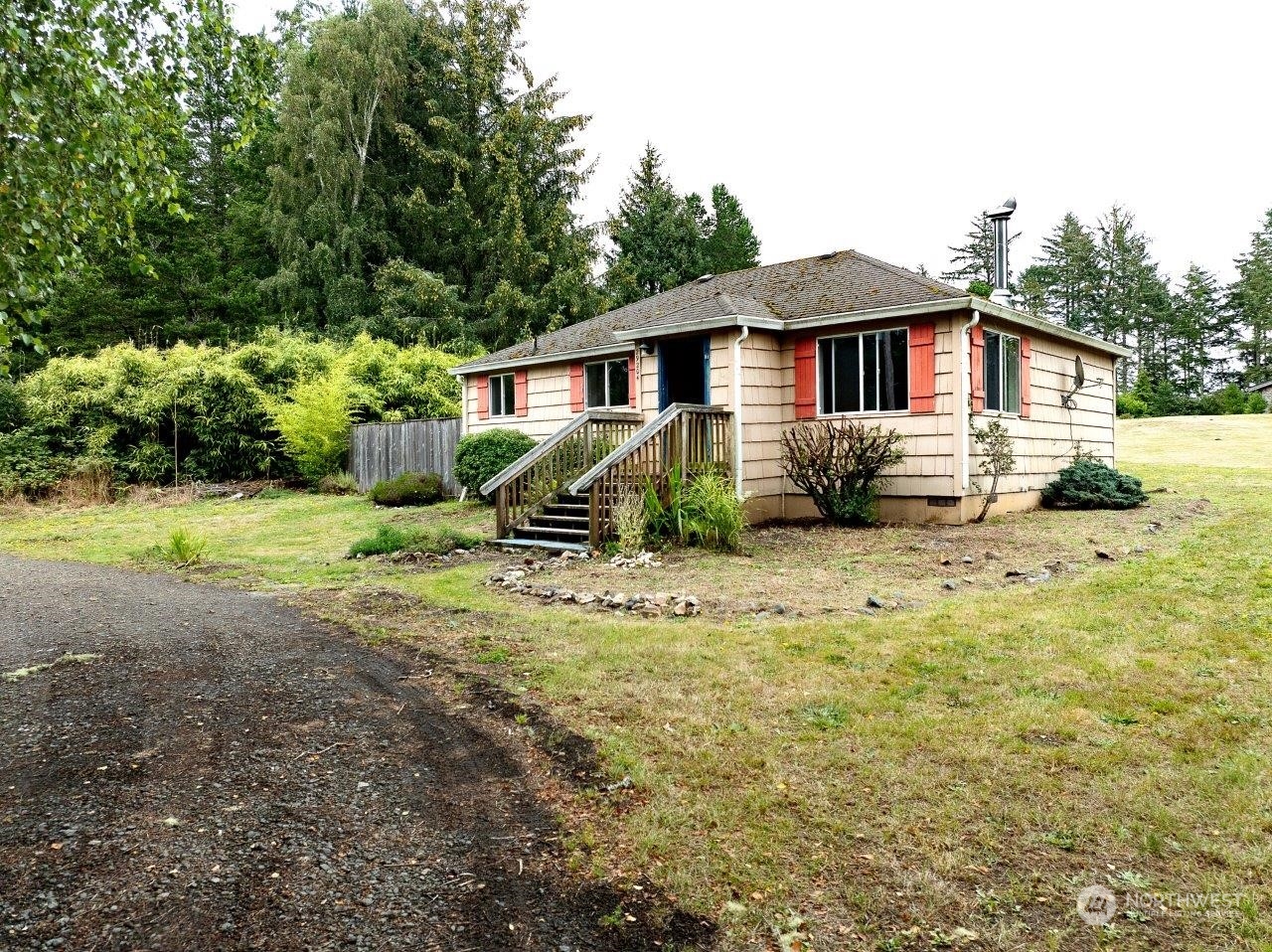 a front view of a house with a yard and trees