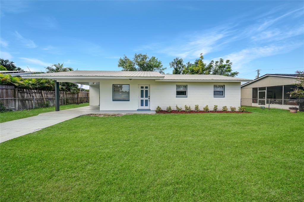 a front view of house with yard and outdoor seating